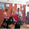 Dr. Amanda Marshall and Dr. Robyn Hakanson present Jerseys from Jersey soccer uniforms to young girls who are part of the Little Sisters program in Kathmandu, Nepal during WOGO’s inaugural medical mission. 