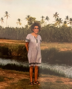 Woman standing along a river.